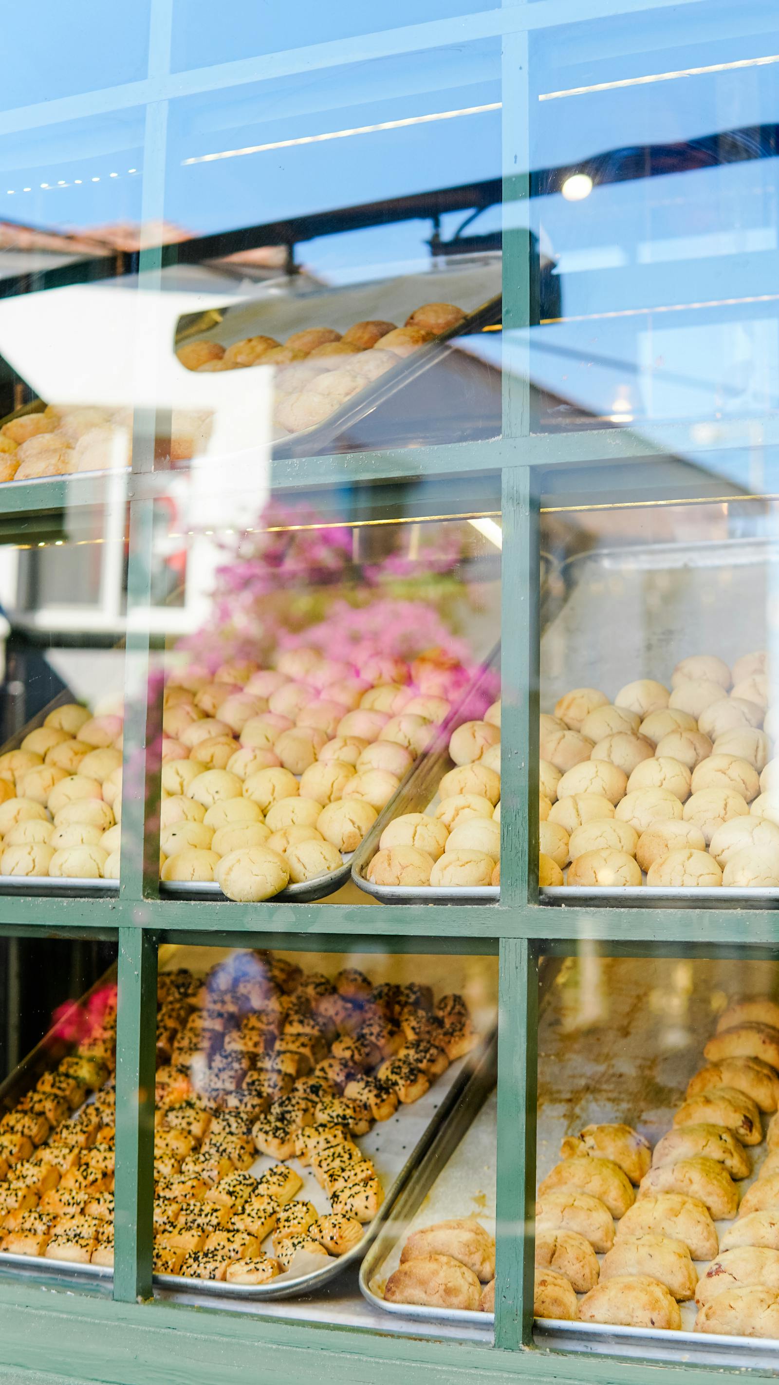 Freshly baked bread on display with a baker behind the counter