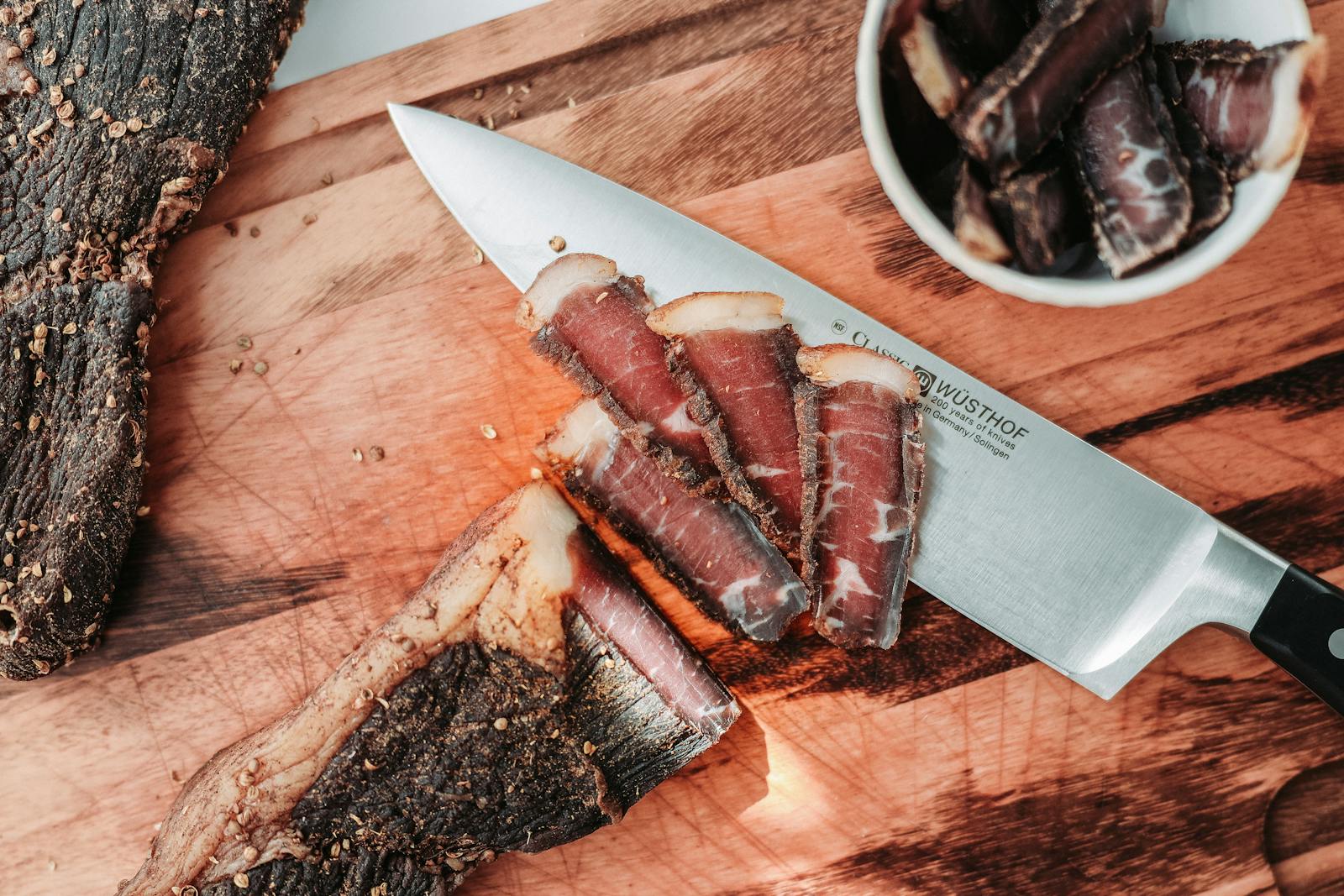 Assorted gourmet cured meats on display at a market stall