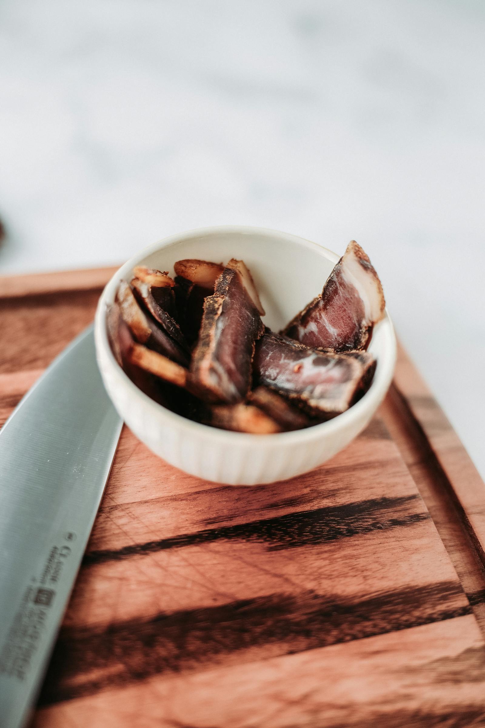 Close-up of traditional droewors sausage with fresh bay leaves