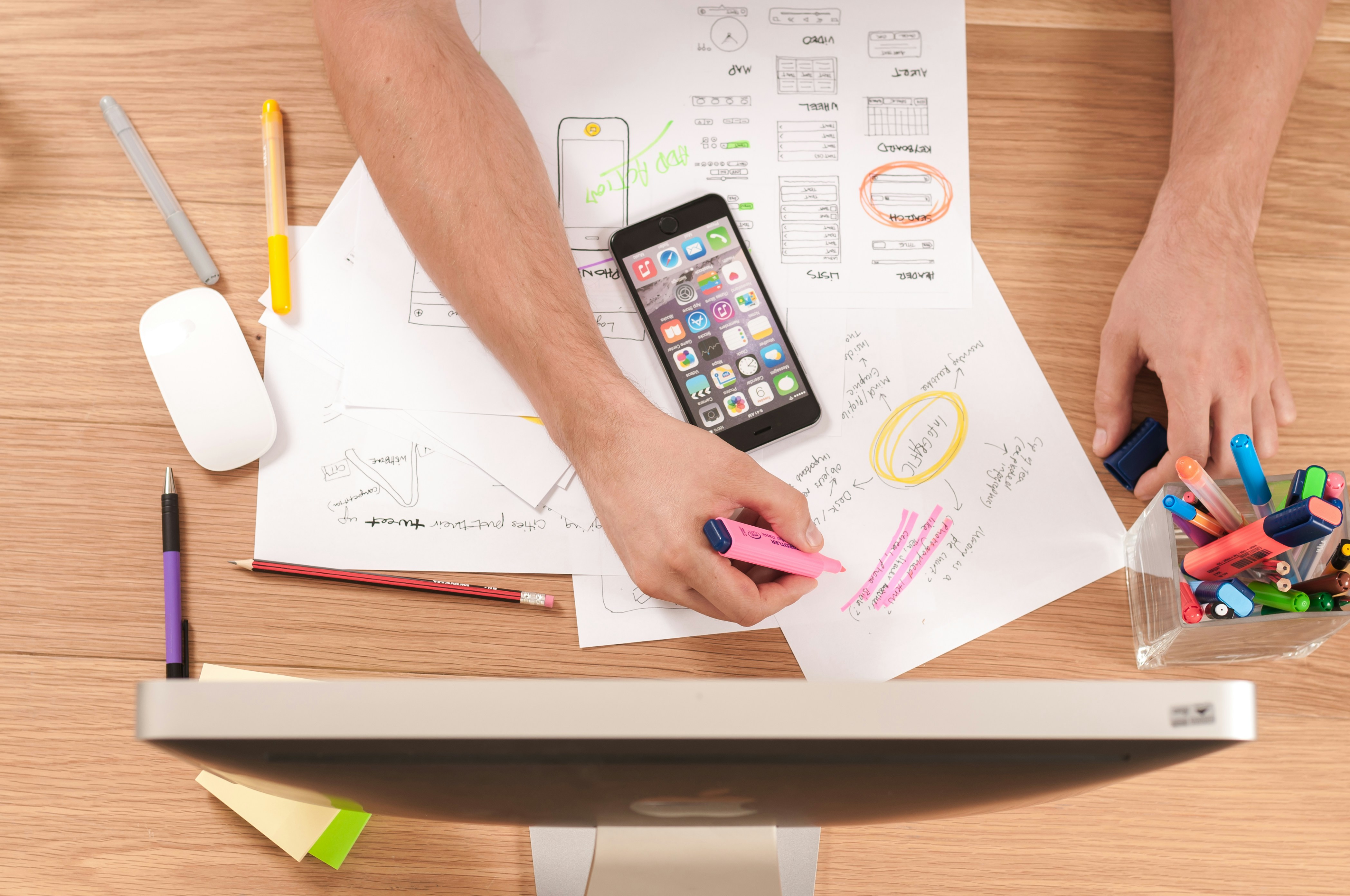 Person multitasking with a laptop and smartphone for cross-channel marketing