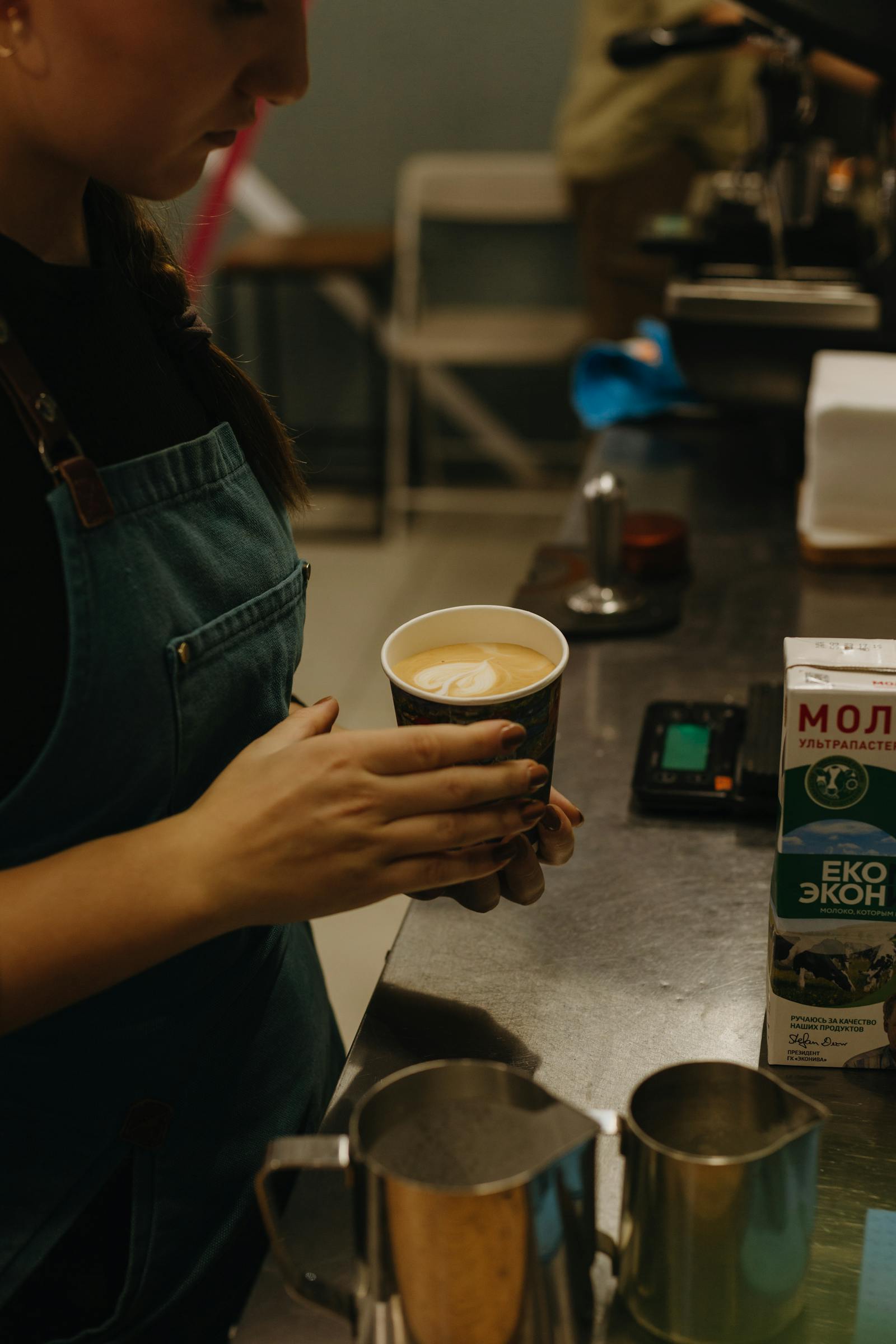 Barista preparing an espresso drink behind the counter