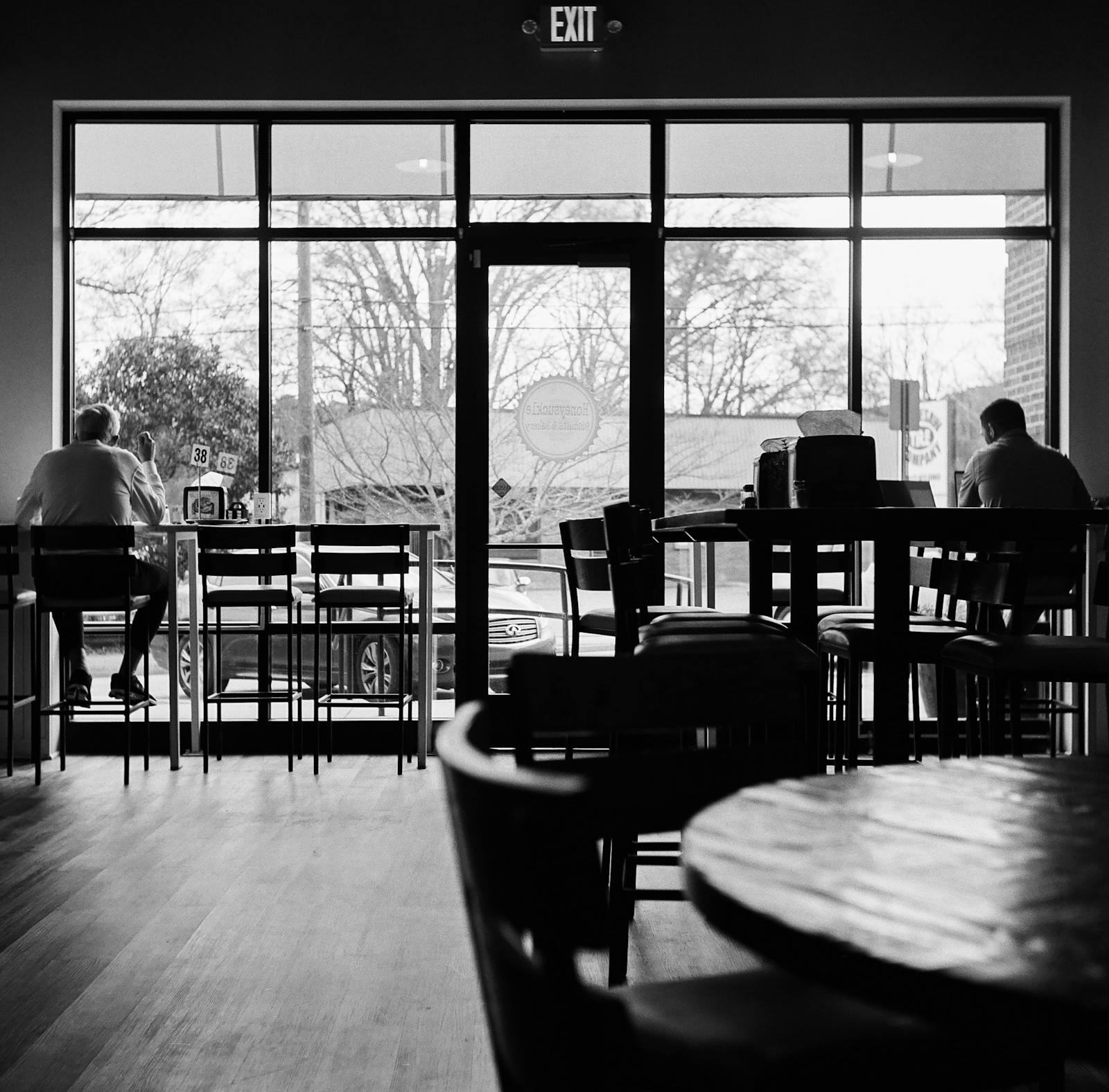 Friendly two-barista coffee shop team at the counter