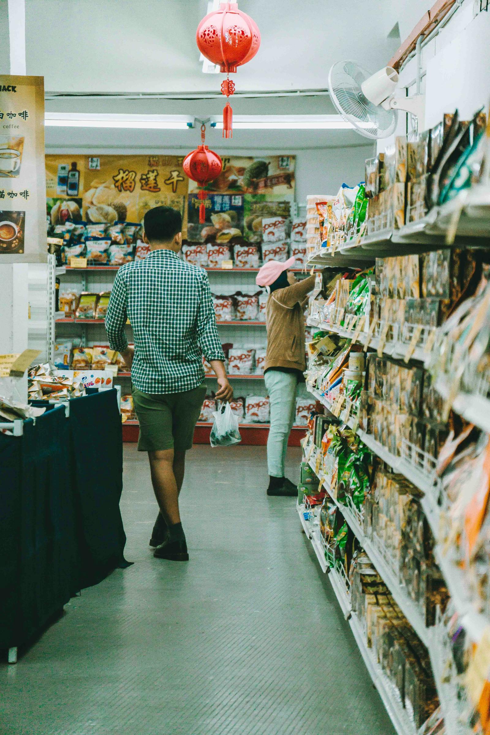 Customer browsing snack shelves in a convenience store