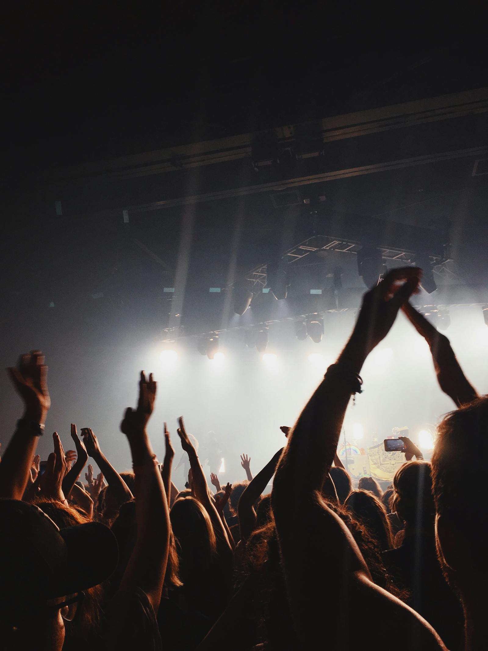 Live band performing on stage with bright lights