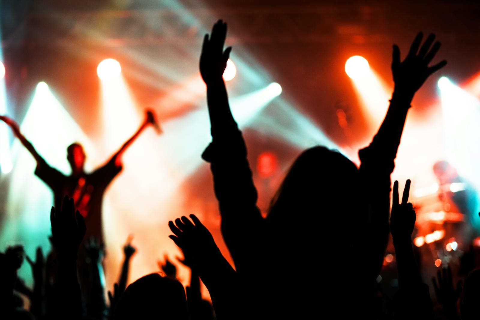 Crowd of concert-goers with phones raised to capture the moment