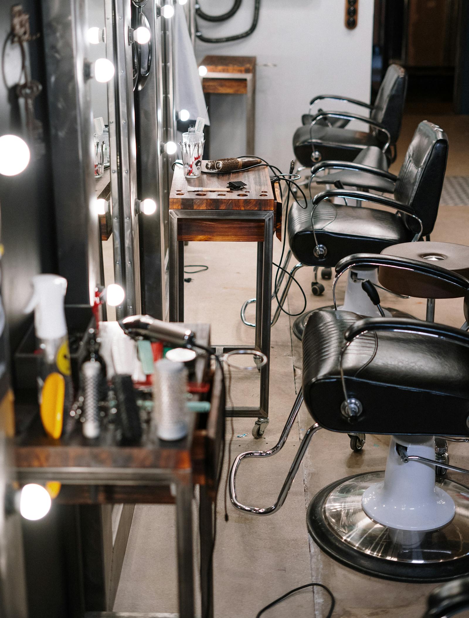 Welcoming hair salon interior with mirrors and a stylist attending a client
