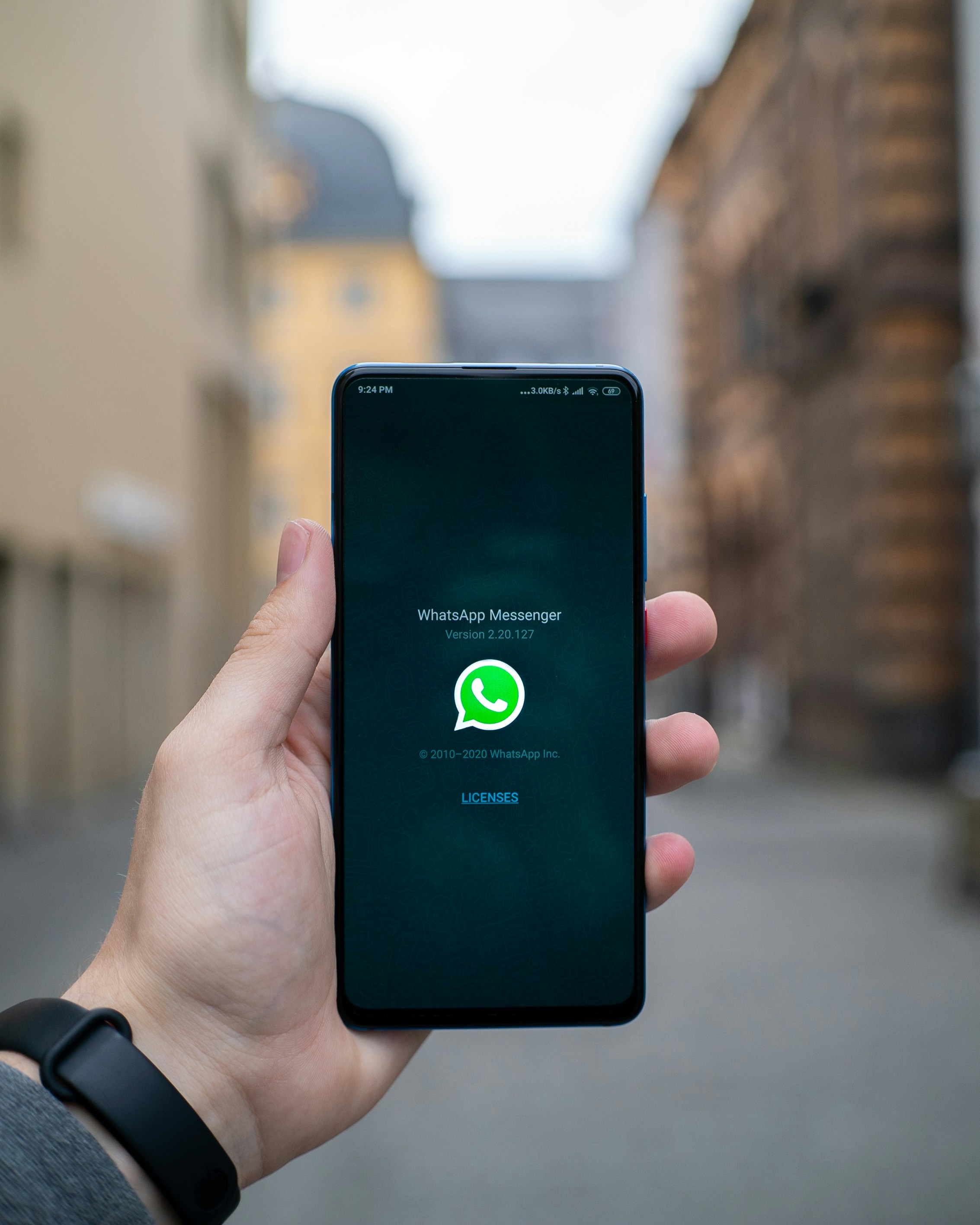 Customer holding their phone, ready to message a business on WhatsApp