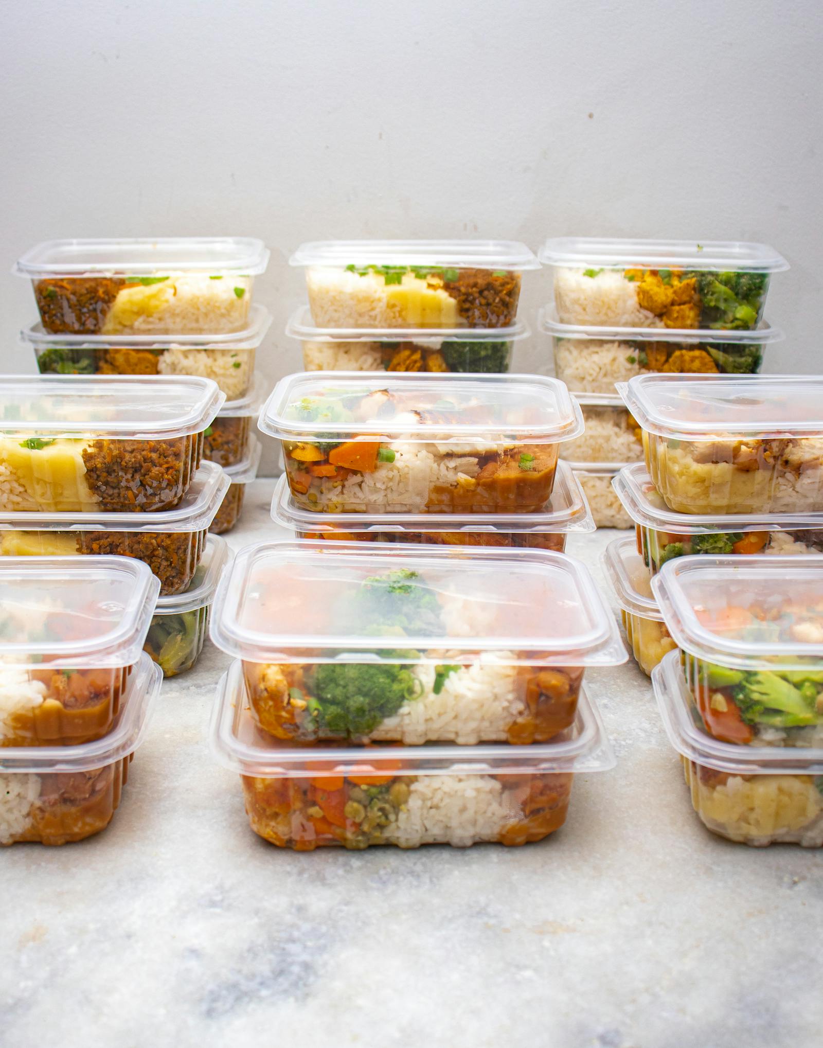 Stack of meal prep containers organised for the week