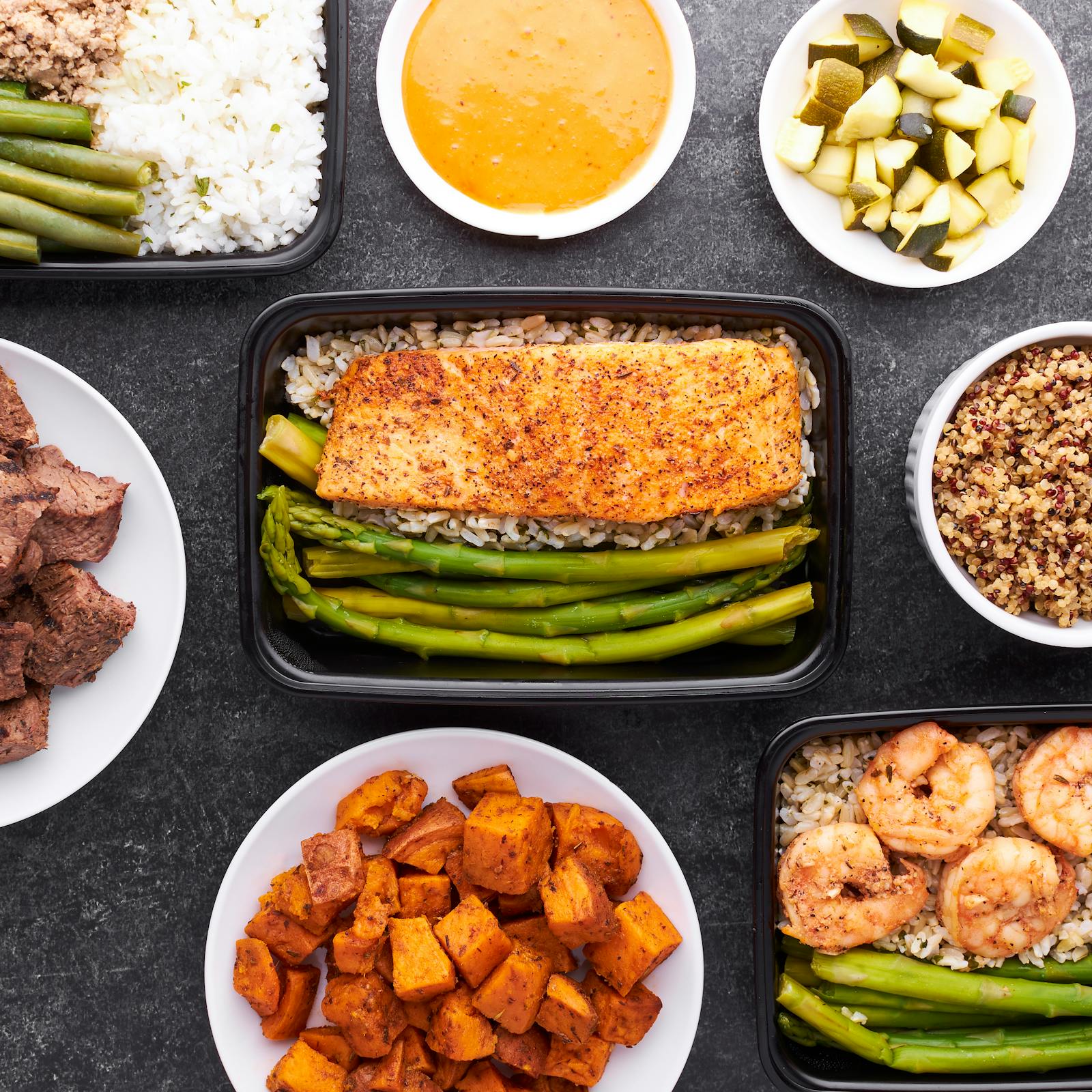 Healthy meal prep with corn, olives, tomatoes and lentils in glass containers